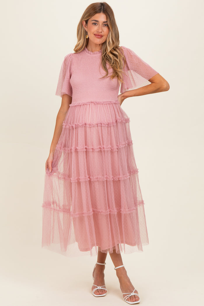 woman wearing a pink maternity maxi dress with tiered tulle layers and short puff sleeves