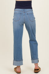 woman wearing light blue maternity jeans with a rolled cuff and a navy blue belly panel, viewed from the back