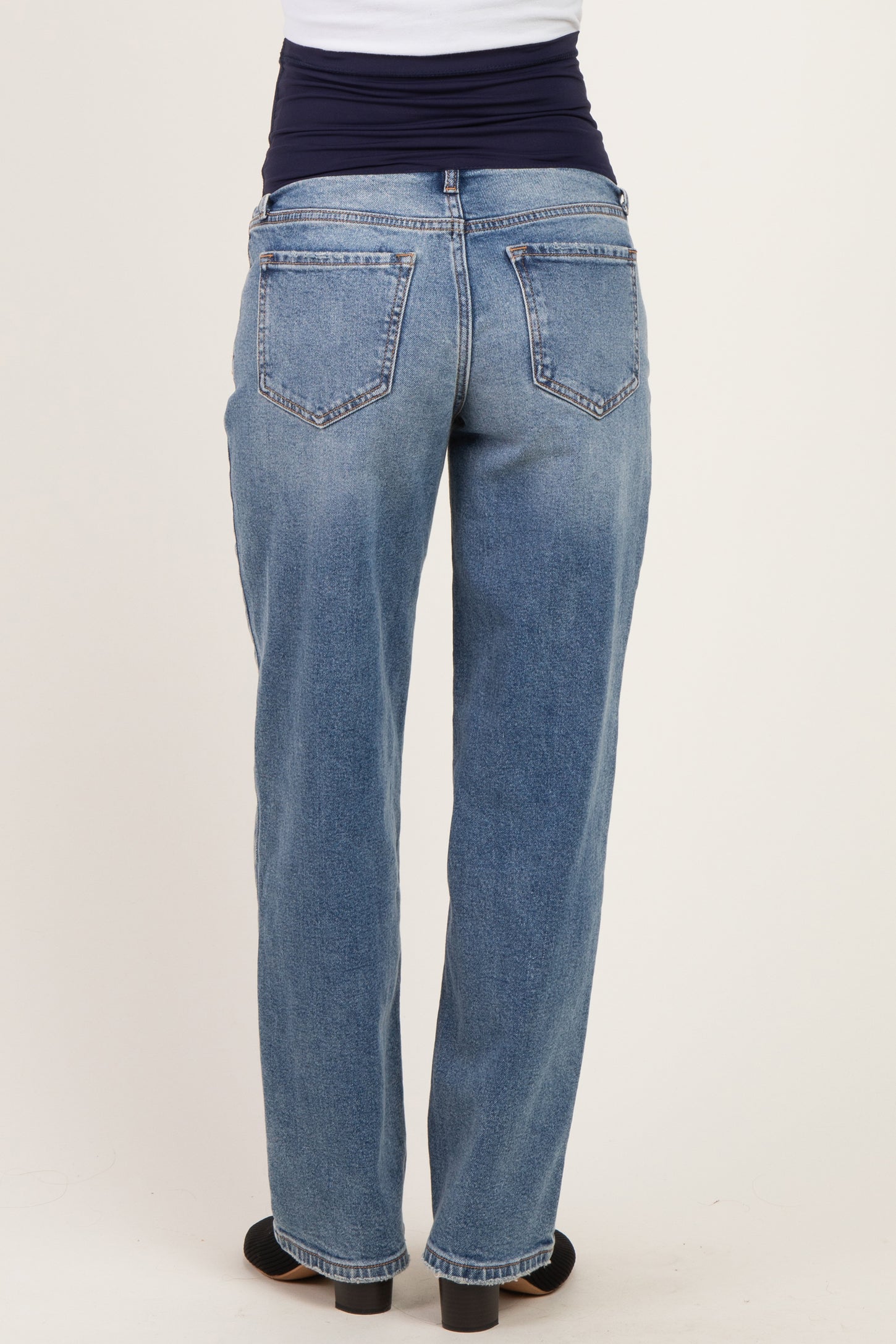 maternity wear light wash denim jeans with a stretchable waistband, shown from the back