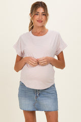 woman wearing a striped maternity top and a denim mini skirt, showing her baby bump
