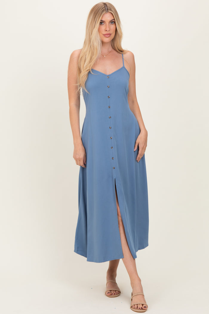 woman wearing a light blue maxi dress with spaghetti straps and a front slit, featuring button details down the center
