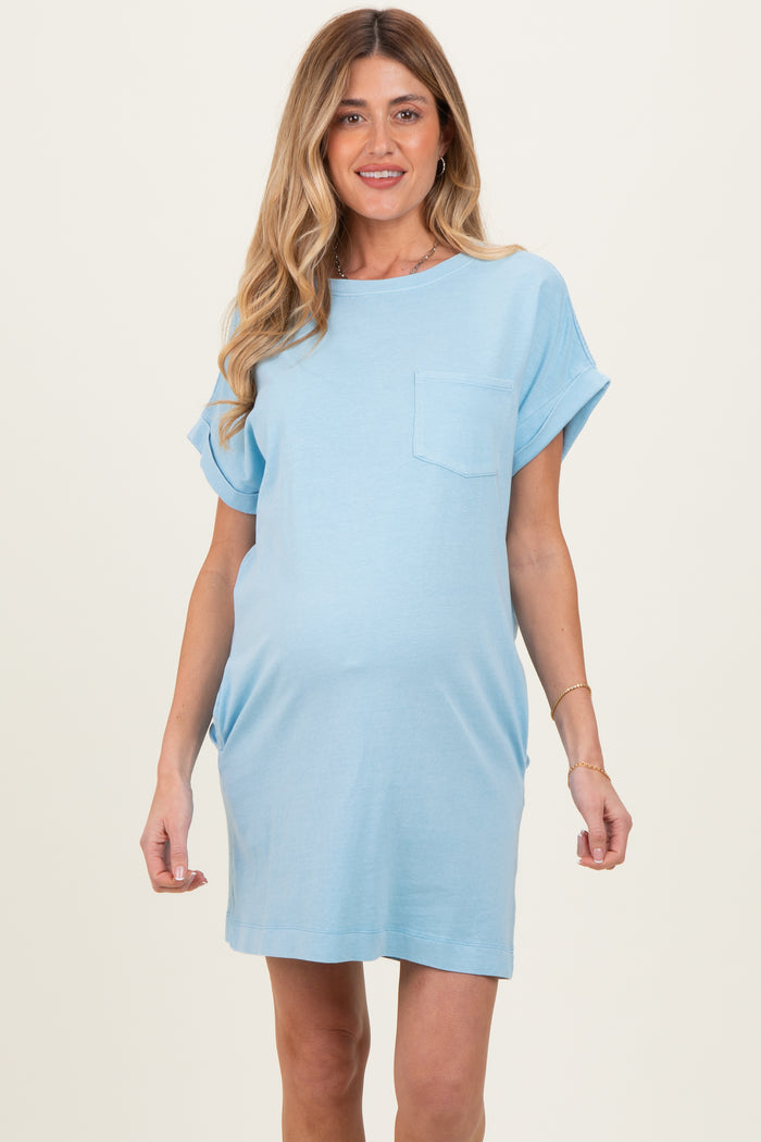 woman wearing a light blue maternity t-shirt dress with a pocket and a visible baby bump