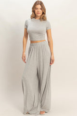 woman wearing a gray cropped t-shirt and matching wide-leg pants in a relaxed fit