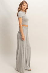 woman wearing a light gray cropped t-shirt and matching wide-leg pants