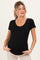 woman wearing a black short sleeve maternity top and showing her baby bump