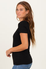 woman wearing a fitted black short sleeve t-shirt with a scoop neckline and side profile pose