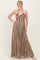 woman wearing a multi-colored patterned maxi dress with a halter neck style and flowy silhouette