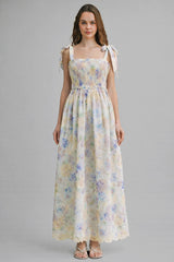 woman wearing a floral maxi dress with smocked bodice and tie shoulder straps