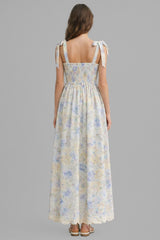 woman wearing a floral maxi dress with tie straps and a smocked back