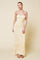 woman wearing a yellow floral maxi dress with thin straps and a ruched bodice