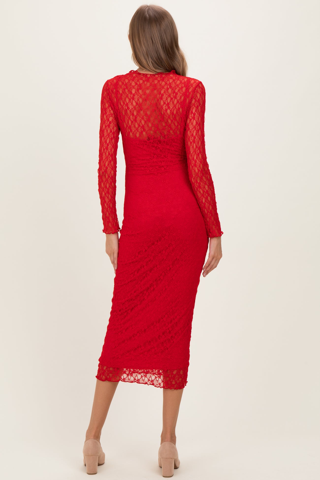 woman wearing a red lace long sleeve midi dress, showing a fitted silhouette and a high neckline, maternity wear