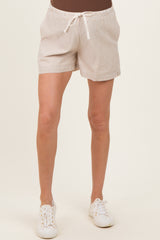 woman wearing beige striped maternity shorts with an elastic waistband and drawstring