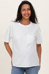 woman wearing a white maternity t-shirt with a front pocket and smiling, showing her baby bump