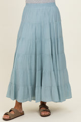 woman wearing a light blue tiered maxi skirt with a flowy design and comfortable sandals
