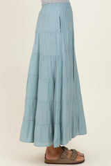 woman wearing a pale blue tiered maxi skirt with a flowy silhouette and side pockets
