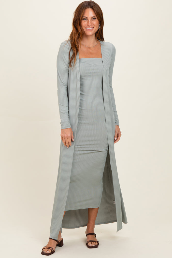 woman wearing a light green ribbed two-piece dress set with a long cardigan and fitted dress