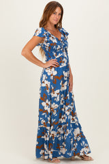 woman wearing a blue floral maxi dress with short sleeves and a tiered skirt