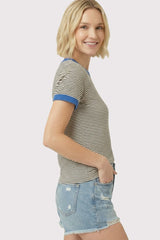 woman wearing a striped short sleeve t-shirt with blue collar and denim shorts