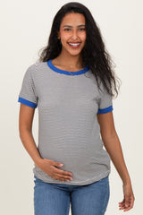 woman wearing a striped maternity t-shirt with blue sleeves and holding her baby bump