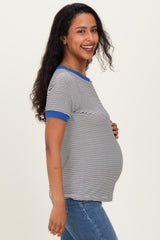 woman wearing a navy and white striped maternity top with blue trim and showing her baby bump