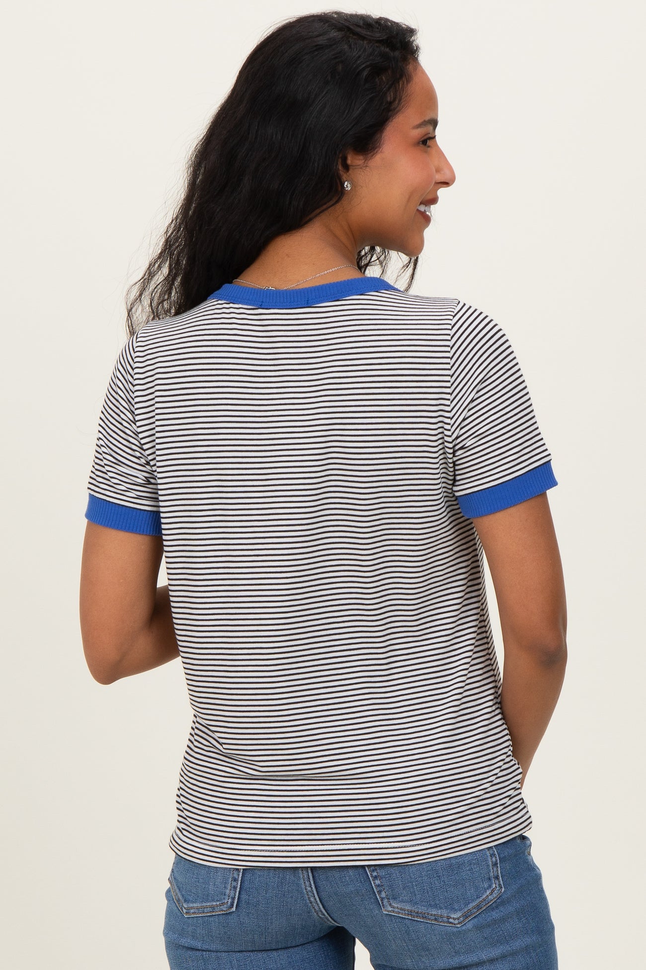 woman wearing a striped maternity t-shirt with blue ribbed trim on the sleeves, showing the back view