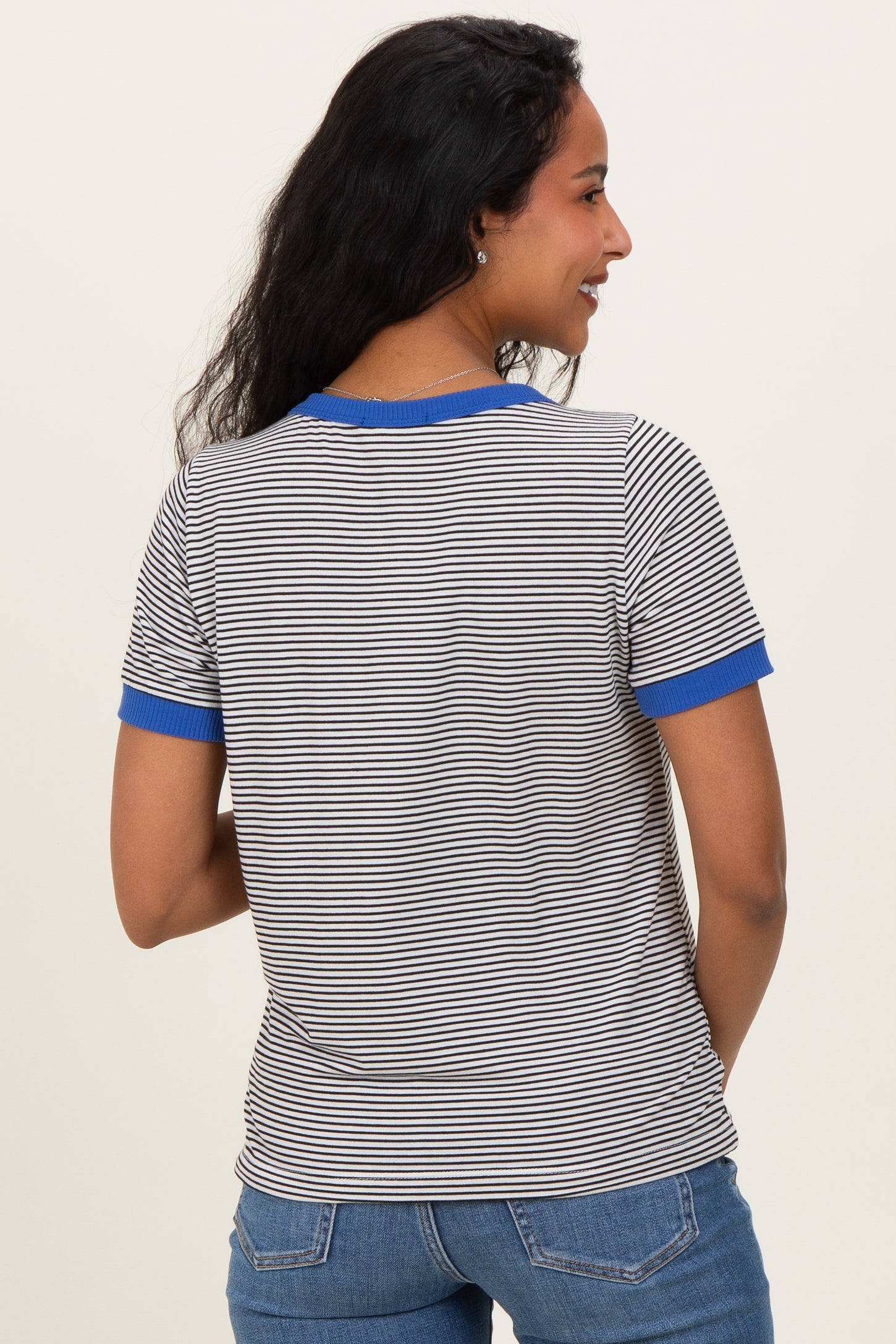 woman wearing a striped maternity t-shirt with blue ribbed trim on the sleeves, showing the back view