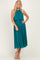 woman wearing a teal pleated midi dress with a halter neck and flowy bodice
