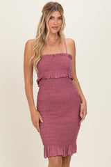woman wearing a dusty rose smocked midi dress with ruffle details and spaghetti straps