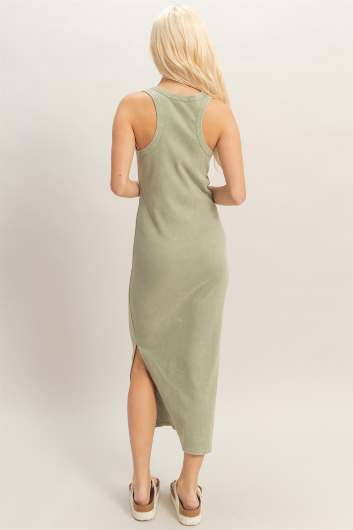 woman wearing a back view of an olive green sleeveless maxi dress with side slits and a fitted silhouette