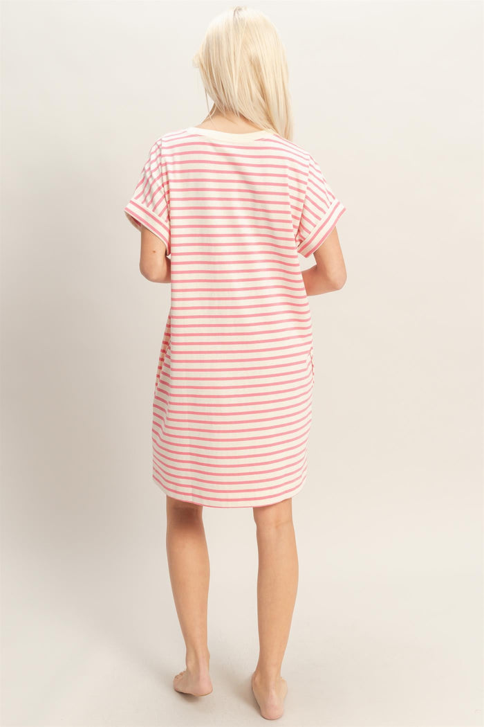 woman wearing a pink and white striped short sleeve nightshirt, seen from the back