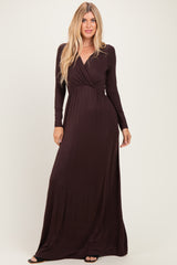 woman wearing a dark burgundy long sleeve maxi dress with a deep v-neck and wrap detail