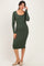 woman wearing a dark green long sleeve fitted midi dress and beige mules