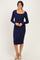 woman wearing a navy blue long sleeve midi dress with a scoop neckline and fitted silhouette