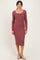 woman wearing a mauve long sleeve fitted midi dress with a scoop neckline