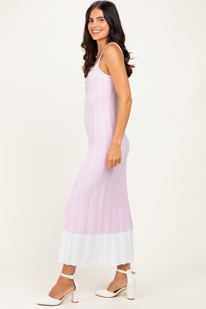 woman wearing a light purple ribbed maxi dress with a white hem and buttons, styled with white heels