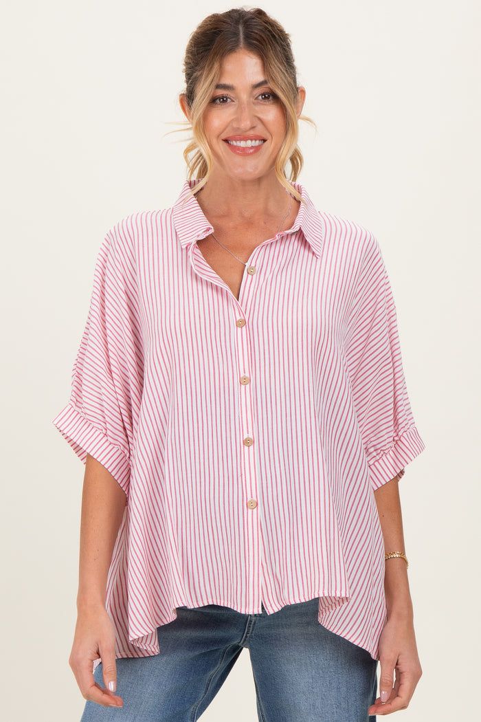woman wearing a red and white striped maternity shirt with a button-down front and rolled sleeves, smiling at the camera