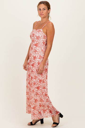 woman wearing a floral red and white maxi dress with thin straps and a relaxed fit