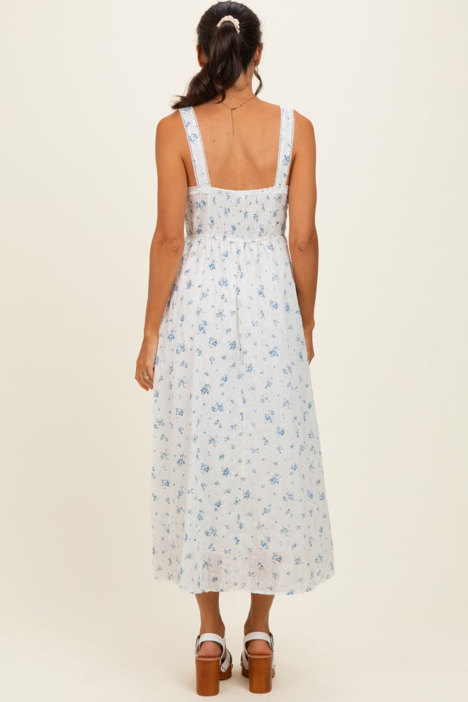 woman wearing a white floral midi dress with a fitted bodice and adjustable straps