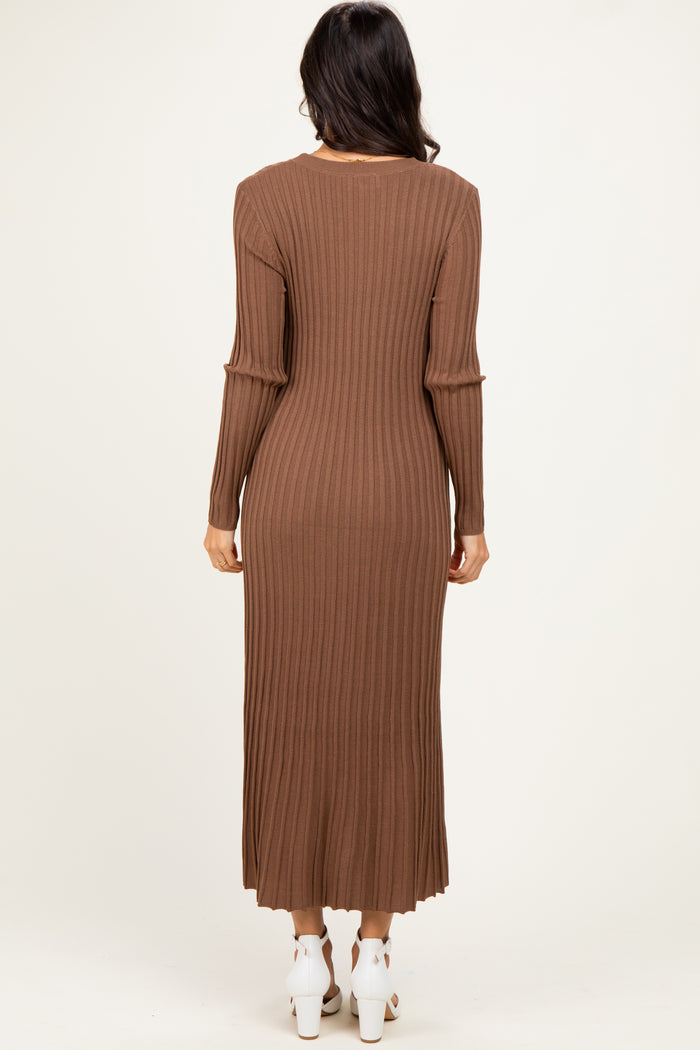 woman wearing a long brown ribbed knit dress with long sleeves, viewed from the back