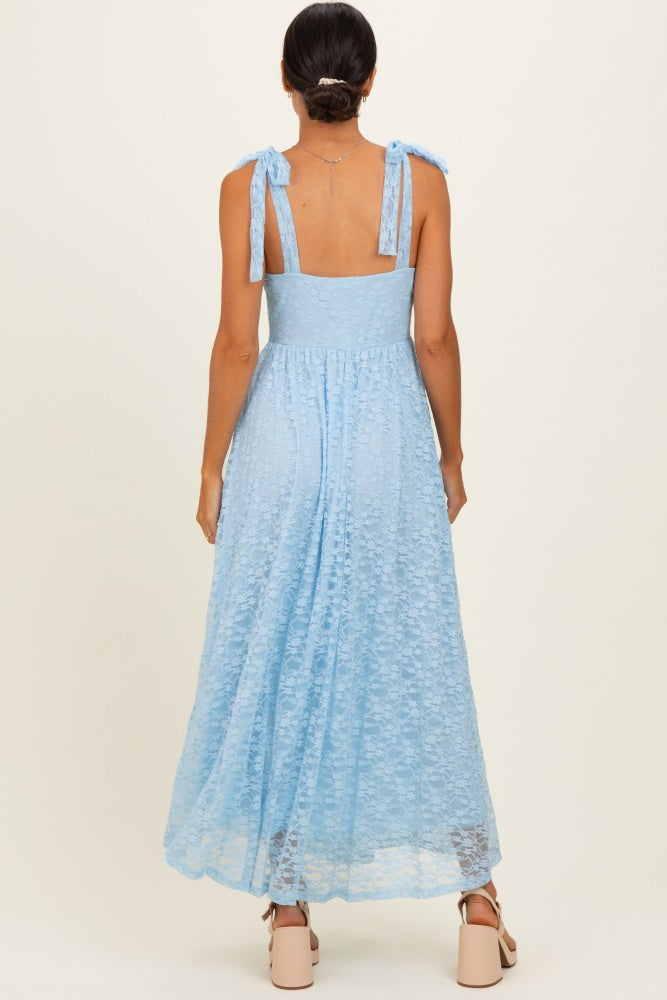 woman wearing a light blue backless maxi dress with tie straps and a flowy silhouette