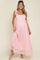 woman wearing a pink lace maternity maxi dress with tie shoulder straps and a visible baby bump