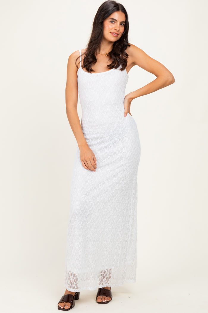 woman wearing a white lace maxi dress with thin straps and a fitted silhouette