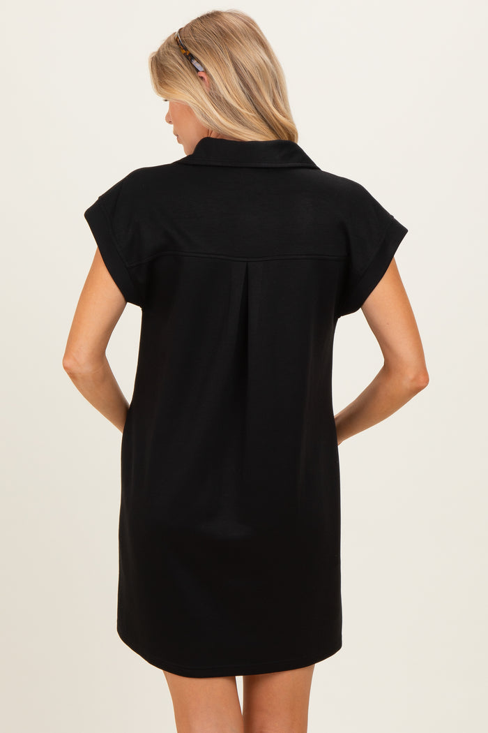 woman wearing a black short sleeve maternity dress, viewed from the back