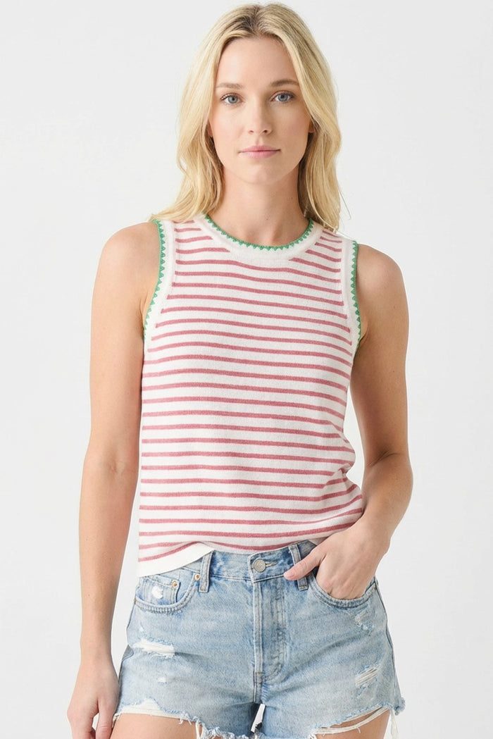 woman wearing a red and white striped sleeveless top with green trim and distressed denim shorts