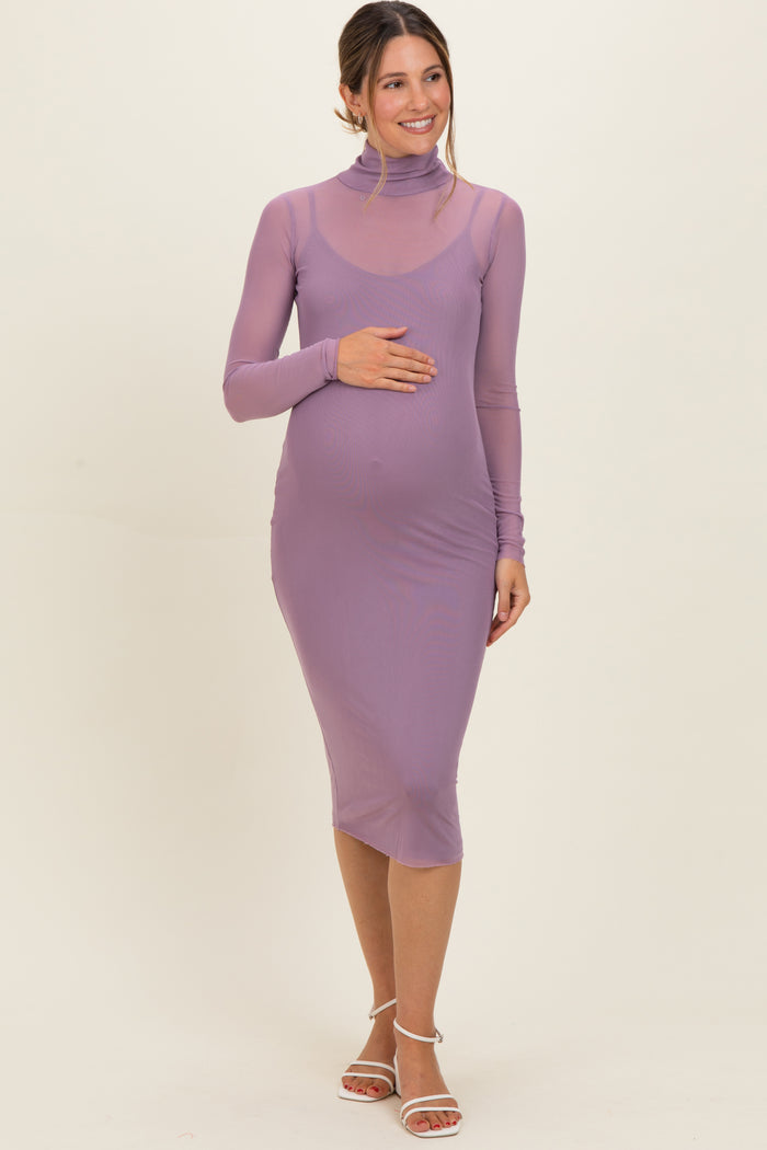 woman wearing a light purple long sleeve maternity dress with a high neck and baby bump visible