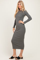 woman wearing a fitted dark gray long sleeve midi dress with a crew neckline and side slit