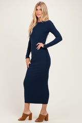 woman wearing a long sleeve navy blue ribbed maxi dress and tan block heel sandals