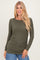 woman wearing an olive green long sleeve top with gathered side detail and casual fit