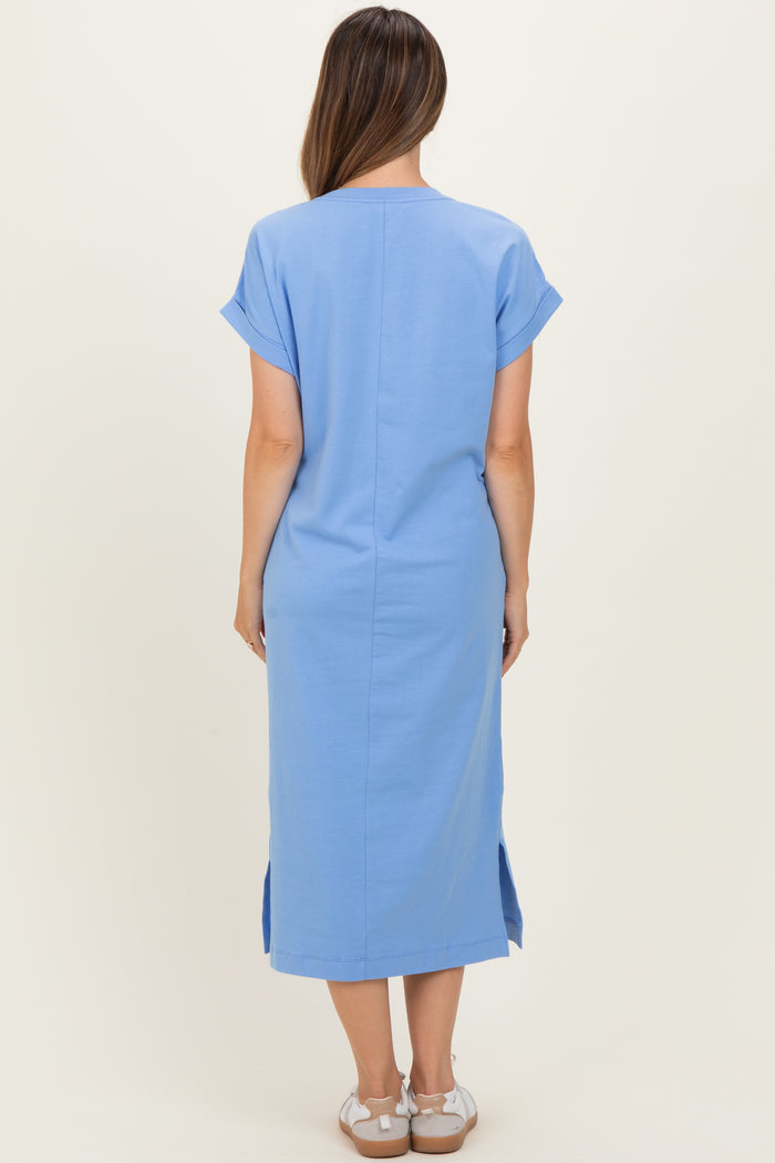 woman wearing a light blue maternity dress with short sleeves and side slits, shown from the back
