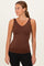 woman wearing a brown sleeveless v-neck tank top paired with black leggings